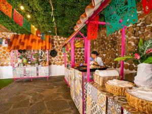 a woman sitting at a counter in a food stand at Playa Blanca Beach Resort - All Inclusive in Playa Blanca