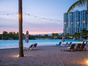 a beach with chaise lounge chairs and a building at Playa Blanca Beach Resort - All Inclusive in Playa Blanca