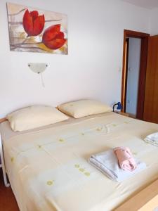 a bedroom with a bed with a towel on it at Matteo in Supetarska Draga