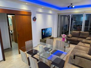a living room with a glass table and chairs at 777 Stars in Paphos