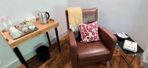 a table with a chair next to a table with a table at Mili's B&B Guest House in Gabrovo