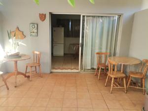 a living room with a table and chairs and a table and a table at My Serenity Guesthouse in Mokopane +13 photos