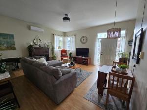 a living room with a couch and a tv at Shediac Beach Suite- Pointe du Chene Wharf and Parlee Beach in Pointe-du-Chêne