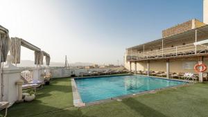a swimming pool on the roof of a building at Emilio Hotel in Luxor
