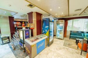 a room with two arcade games and a table at Emilio Hotel in Luxor