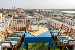 a table with a blue table cloth on a balcony at Emilio Hotel in Luxor