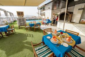 a blue table with plates of food on it at Emilio Hotel in Luxor