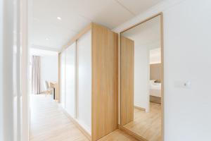 a large mirror in a room with a bedroom at R2 Buganvilla Hotel & Spa in Morro del Jable