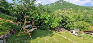 a bench sitting in the grass in a garden at Veža na vlásku in Háj
