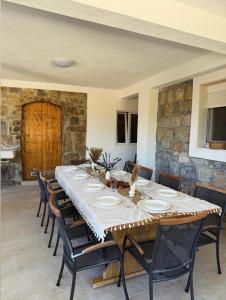 a large dining room with a long table and chairs at Villa with stunning Mountain Views and Authentic Croatian Stone House near Split and Sea in Žrnovnica