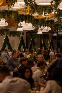 a group of people sitting at tables in a room at The Spot Resort in Poljanski Lug +52 photos