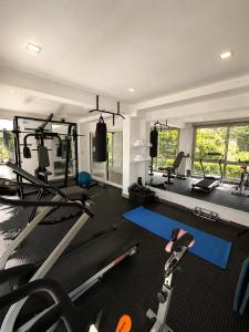a gym with several treadmills and weights in it at La Olivia Hotel Boutique & Spa in La Falda