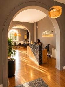 a woman sitting at a counter in a lobby at La Olivia Hotel Boutique & Spa in La Falda +38 photos