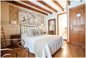 a bedroom with a bed and a wooden floor at Pensión Arbidel in Ribadesella