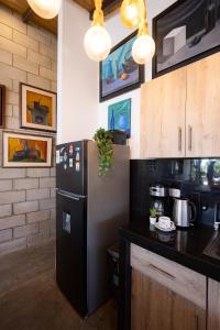 a kitchen with a black refrigerator in a room at Casa Arte by Vibrant in Vichayito