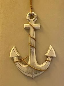 a white cross hanging on a wall at Addor 'e Mare in Bacoli