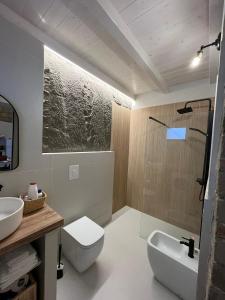 a bathroom with a toilet and a sink at Addor 'e Mare in Bacoli +20 photos