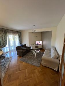 a living room with a couch and a table at Bar Luxury Apartment in Bar