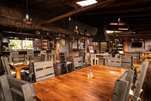 a dining room with a wooden table and chairs at La Bicok EcoLodge in Mindo
