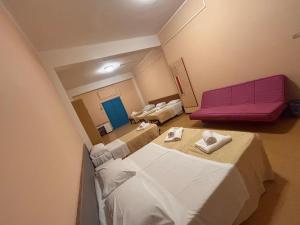 a hospital room with two beds and a purple couch at Campus Baia Serena in Bellaria-Igea Marina +16 photos