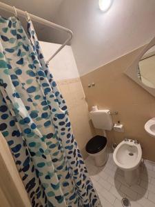 a bathroom with a toilet and a shower curtain at Campus Baia Serena in Bellaria-Igea Marina