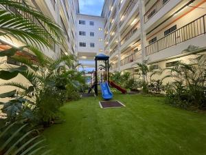 a playground in the middle of a building with a playground at Studio Inap Seri Iskandar in Kampong Bota Road