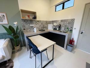 a small kitchen with a table and a sink at Studio Inap Seri Iskandar in Kampong Bota Road +18 photos