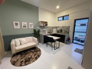 a living room with a couch and a table at Studio Inap Seri Iskandar in Kampong Bota Road