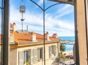 a window view of a building with a view of the ocean at Maison Julien 3 in Menton