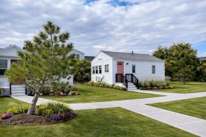 a white house with a tree in the yard at Ocean Surf at York Beach in York