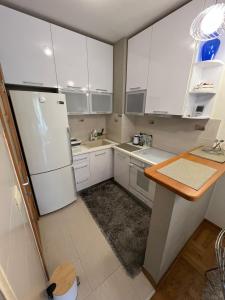 a kitchen with white cabinets and a white refrigerator at Bar Luxury Apartment in Bar