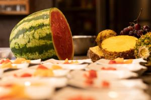 a close up of a melon and other fruits on a table at La Bicok EcoLodge in Mindo +86 photos