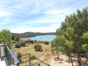 a view of a lake from a balcony at Slanraj apartman in Jadrtovac
