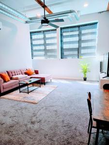 a living room with a pink couch and a table at Historic Federal Hill 1Br Loft apt with onsite Gym and Barbershop in Providence