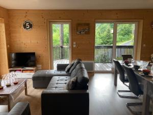a large living room with couches and a television at Les Estives R-2G in Le Lioran