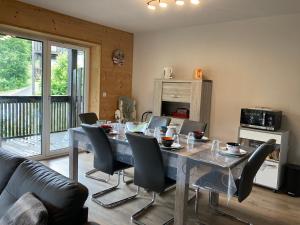 a dining room with a table and chairs at Les Estives R-2G in Le Lioran