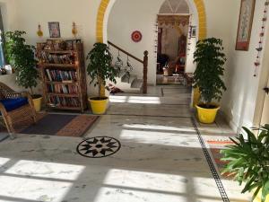 a living room with potted plants and a staircase at Seventh Heaven Inn Rishikesh in Rishīkesh