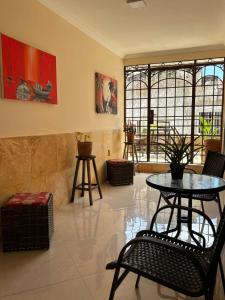 a room with a table and chairs and some paintings at Maré Praia Hotel in Fortaleza
