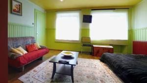 a living room with a couch and a table at Lina et Anaë in Saint-Nabor