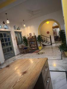 a kitchen with a wooden counter top in a room at Seventh Heaven Inn Rishikesh in Rishīkesh