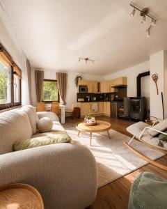 a living room with a couch and a table at Wellspace Forest Retreat in Karlovy Vary