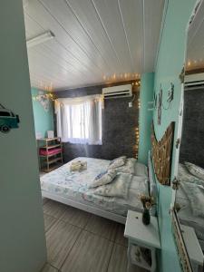 a bedroom with a large bed in a room at Suíte Maresia - Pousada Castelo do Luar in Penha