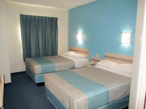 a hotel room with two beds and a window at Motel 6-Kingdom City, MO in Kingdom City