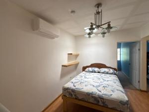 a bedroom with a bed and a chandelier at Casa San Carlos in La Coyotera