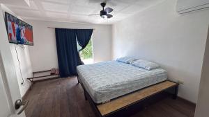 a bedroom with a bed and a ceiling fan at Casa San Carlos in La Coyotera