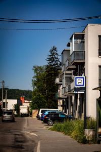 a parking lot with cars parked next to a building at Apartman Pred polom in Trenčín