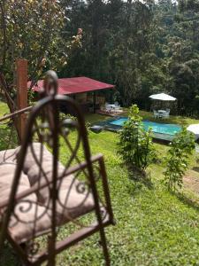 a view of a backyard with a swimming pool at Pousada Chateau Bella Vista in Campos do Jordão