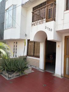 a building with a courtyard with plants in front of it at El Palmar in Palmira