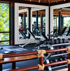 a gym with several treadmills and elliptical machines at Luxury Beachfront Condo at Krystal Grand Resort - NEWLY REMODELED & NEWLY FURNISHED in Bucerías