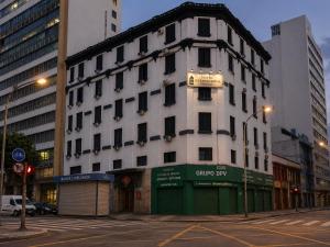 a white building with a sign on the side of it at Hotel Internacional São Paulo in São Paulo